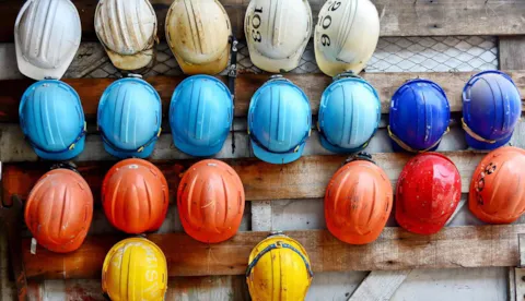 Colorful hard hats in a row